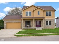 Charming two-story home with brick and siding, attached garage, and well-maintained lawn at 3748 Pawnee Trl, Columbus, IN 47203