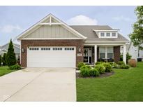 Charming single-Gathering home with red brick, a white garage door, and well-manicured landscaping at 5875 Mill Haven Way, Noblesville, IN 46062