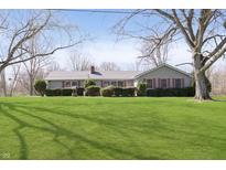 Charming ranch-style home with a well-manicured lawn and mature trees at 5913 W Maple Dr, Frankton, IN 46044
