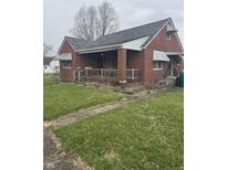 Charming one-story brick home featuring a covered front porch and classic architectural details at 6206 W Us Highway 40, Stilesville, IN 46180