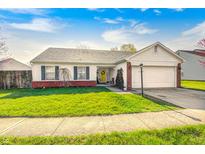 Charming single-story home with a well-manicured lawn, attached garage, and inviting curb appeal at 6431 Meadowpond Way, Indianapolis, IN 46235