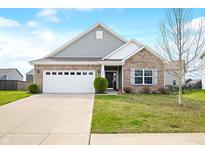 Charming single-Gathering home showcasing a well-manicured lawn, attached two-car garage, and tasteful brick and gray siding at 7574 Merrick Dr, Brownsburg, IN 46112