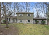 Charming two-story home with stone accents, shutters, and a well-maintained front lawn at 8711 Kensington Dr, Noblesville, IN 46060