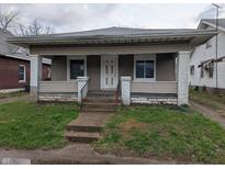 Charming single-story home featuring a covered front porch and a quaint yard at 1524 Ohio Ave, Anderson, IN 46016