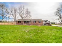 Charming brick home with a well-maintained lawn and mature trees, showcasing its inviting curb appeal at 16371 State Road 38 E, Noblesville, IN 46060