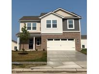 Charming two-story home with a well-manicured lawn and a spacious two-car garage at 2220 Foothill Dr, Greenfield, IN 46140