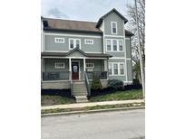 Charming exterior view with a welcoming front porch and beautiful landscaping at 2250 N Pennsylvania St # 8, Indianapolis, IN 46205