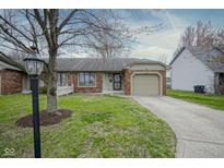 Charming single-story home with brick and siding exterior, featuring an attached garage and well-maintained lawn at 235 E County Line Rd, Greenwood, IN 46143