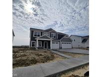 Two-story home with a three-car garage, gray siding, white trim and a concrete driveway at 2721 Bo Street W, Plainfield, IN 46168