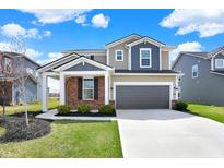 Beautiful two-story home featuring a two-car garage, landscaped yard, and a welcoming covered front porch at 4941 Oak Hill Dr, Lebanon, IN 46052
