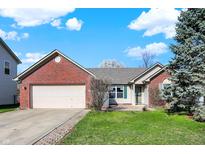 Charming brick home with a well-maintained lawn and attached two car garage at 5426 Black Bear Cir, Indianapolis, IN 46239