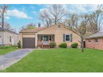 Charming single-story home featuring a well-maintained lawn and attached garage at 5734 Hillside Ave, Indianapolis, IN 46220