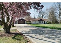 Charming ranch home with long driveway, basketball hoop, mature trees and beautiful magnolia tree at 6047 W 56Th St, Indianapolis, IN 46254