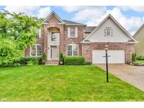Charming two-story brick home with a well-manicured lawn and arched entryway at 6071 Sugar Pine Dr, Avon, IN 46123