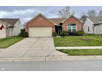 Charming single-story red brick home with a two-car garage and a well-maintained front yard at 6083 White Birch Dr, Fishers, IN 46038