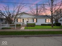 Charming single-story home with a cozy covered front porch and manicured lawn at 625 7Th St, Shelbyville, IN 46176