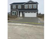 New two story home with gray siding, a white garage door, and professional landscaping at 7182 Finley Creek Dr, Whitestown, IN 46075