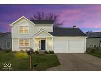 Two-story home featuring a well-manicured lawn, two-car garage, and a traditional design at 7914 Cardinal E Cv, Indianapolis, IN 46256