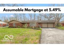 Charming single-story brick home featuring an attached two-car garage and a well-maintained front yard at 7915 Allisonville Rd, Indianapolis, IN 46250