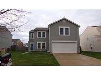 Charming two-story home with a two-car garage, green lawn, and light-gray siding at 796 Hickory Pine Dr, Whiteland, IN 46184