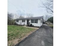 Charming single story home featuring a well-maintained lawn and a long driveway at 1024 Foltz St, Indianapolis, IN 46241