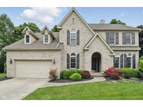 Stunning two-story brick home features an attached garage and inviting front yard landscaping at 11974 Volcanic Rock Dr, Fishers, IN 46037