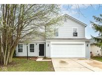 Charming two-story home features a well-maintained lawn and an attached two-car garage at 12455 Deerview Dr, Noblesville, IN 46060