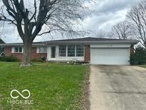 Charming single-story home with a well-maintained lawn and a two-car garage at 2146 Lawrence Ave, Indianapolis, IN 46227