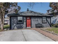 Charming single story home with grey siding and a red front door at 2938 Hillside Ave, Indianapolis, IN 46218