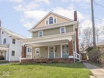 Charming two-story home with a covered front porch and a well-manicured lawn at 317 E 37Th St, Indianapolis, IN 46205