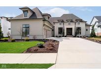 Beautiful home with a long driveway, well manicured lawn, and a two car garage at 4258 Hamilton Run, Zionsville, IN 46077
