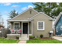 Charming home with a cozy front porch featuring a seating area at 4721 Ralston Ave, Indianapolis, IN 46205