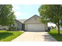 Charming single-story home featuring a brick facade, well-maintained lawn, and a two-car garage at 5406 Shamus Dr, Indianapolis, IN 46235