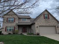 Charming two-story brick home with an attached two-car garage and well-maintained lawn at 561 Prince Dr, Greenwood, IN 46142