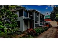 Charming two-story home with a lush landscaped yard and a welcoming front entrance at 634 Dorman St, Indianapolis, IN 46202