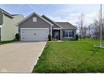 Charming home featuring a well-manicured lawn and a convenient two-car garage at 7527 Derek Dr, Camby, IN 46113