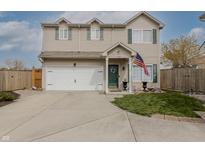 Charming two-story home with an attached garage, manicured lawn, and an American flag at 768 Pine Lake Dr, Greenwood, IN 46143