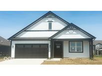 Beautiful one-story home with a black-and-white color scheme and a two-car garage at 8727 Duncan St, Fortville, IN 46040