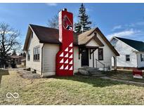 Charming one story home featuring a bold chimney design and freshly cut lawn at 921 W Carson St, Muncie, IN 47303