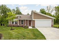 Charming single-story home with manicured lawn, brick accents, and attached two-car garage at 1024 Cyprian Way, Lebanon, IN 46052
