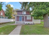 Charming home with a blue front door, well-kept lawn, and tasteful landscaping at 1139 E 35Th St, Indianapolis, IN 46205