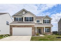 Charming two-story home with a brick and siding exterior, attached two-car garage, and a well-manicured front yard at 1455 Bigleaf Dr, Sheridan, IN 46069