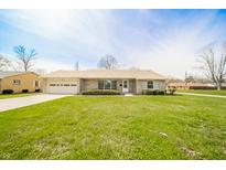 Charming single-story home featuring a stone facade, attached garage, and well-manicured front lawn at 1611 Orchard Ln, Anderson, IN 46011
