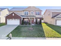 Charming two-story home with a well-manicured lawn, attached two-car garage, and inviting front porch at 1907 Wedgewood Pl, Avon, IN 46123