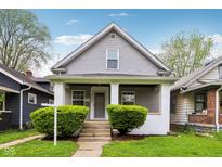 Charming two-story home with a cozy front porch and well-maintained landscaping at 422 N Oxford St, Indianapolis, IN 46201