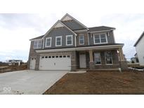 Newly built two-story home showcasing a three-car garage and stone and siding exterior at 4952 Cinnabar Trl, Brownsburg, IN 46112