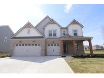 Beautiful two-story home featuring a three-car garage, brick accents, and craftsman-style details at 4960 Cinnabar Trl, Brownsburg, IN 46112