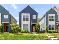 Charming blue two-story home with manicured lawn and front garden at 64 Central Greens Blvd, Indianapolis, IN 46222