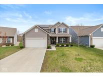 Charming two-story home featuring a well-maintained lawn and a two-car garage at 6535 Heben Ct, Indianapolis, IN 46113