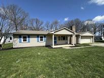 Charming single-story home with blue shutters and a well-maintained front lawn at 6672 E 225 S, Whitestown, IN 46075